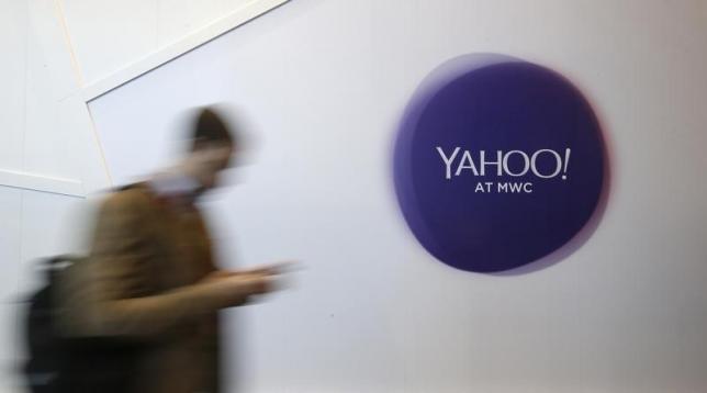 A man walks past a Yahoo logo during the Mobile World Congress in Barcelona