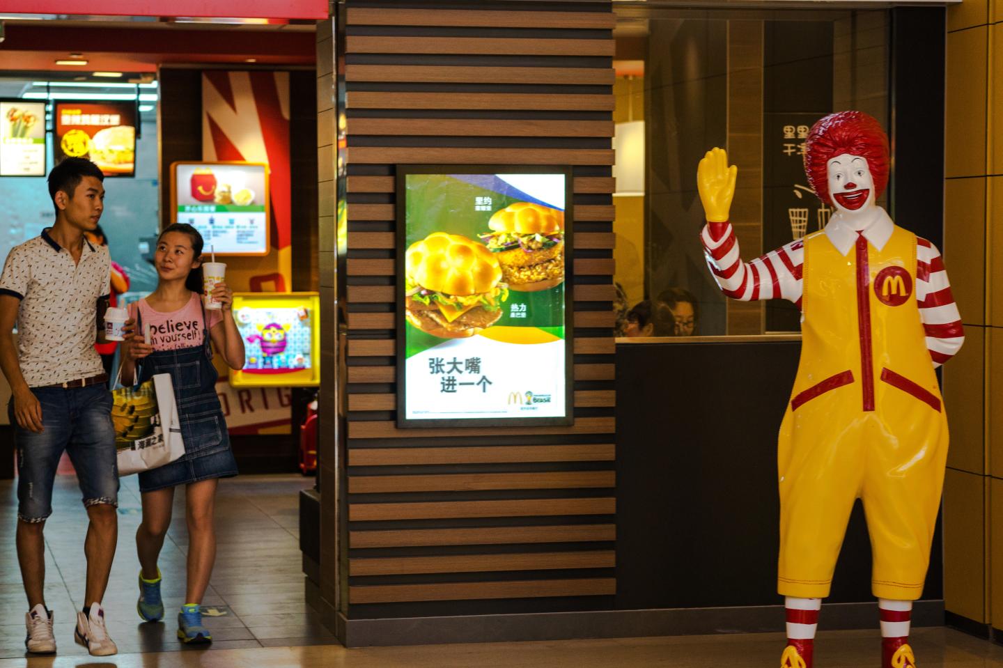 Customers and Ronald McDonald in a McDonalds restaurant