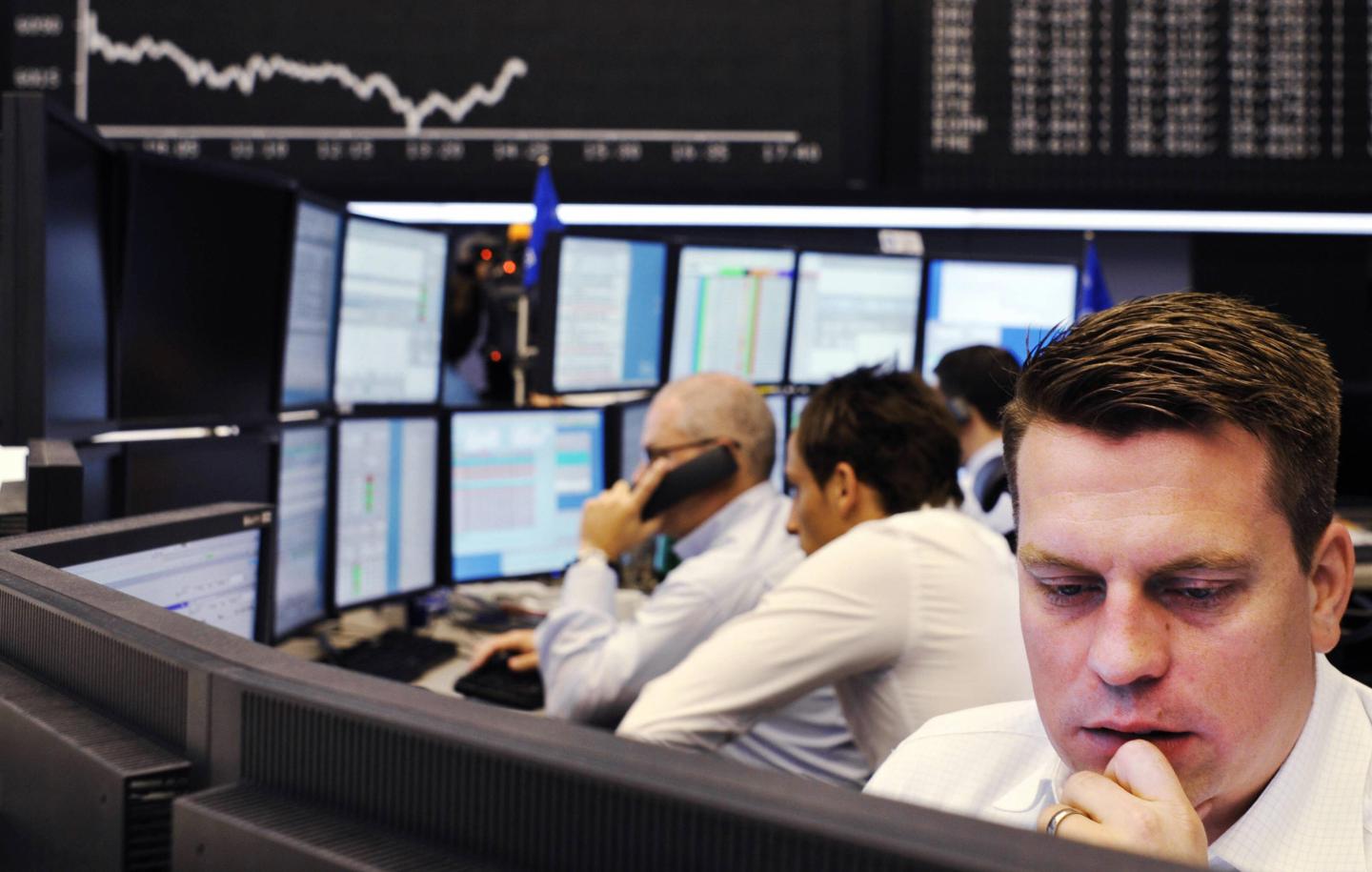 Brokers look at their screens at Frankfu