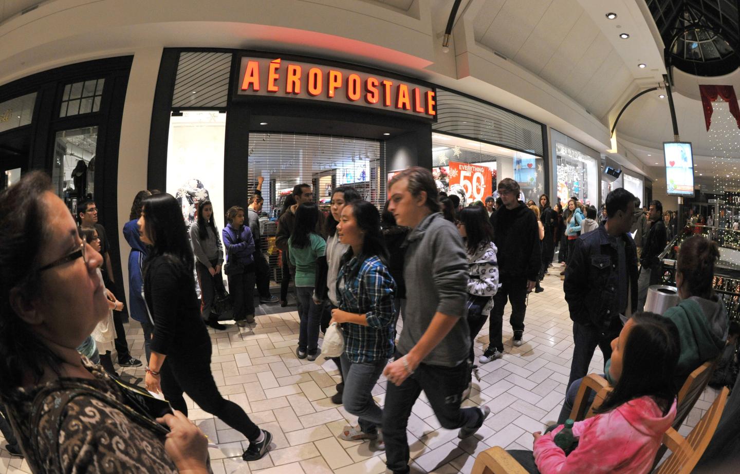 Shoppers walk past the Aeropostale store