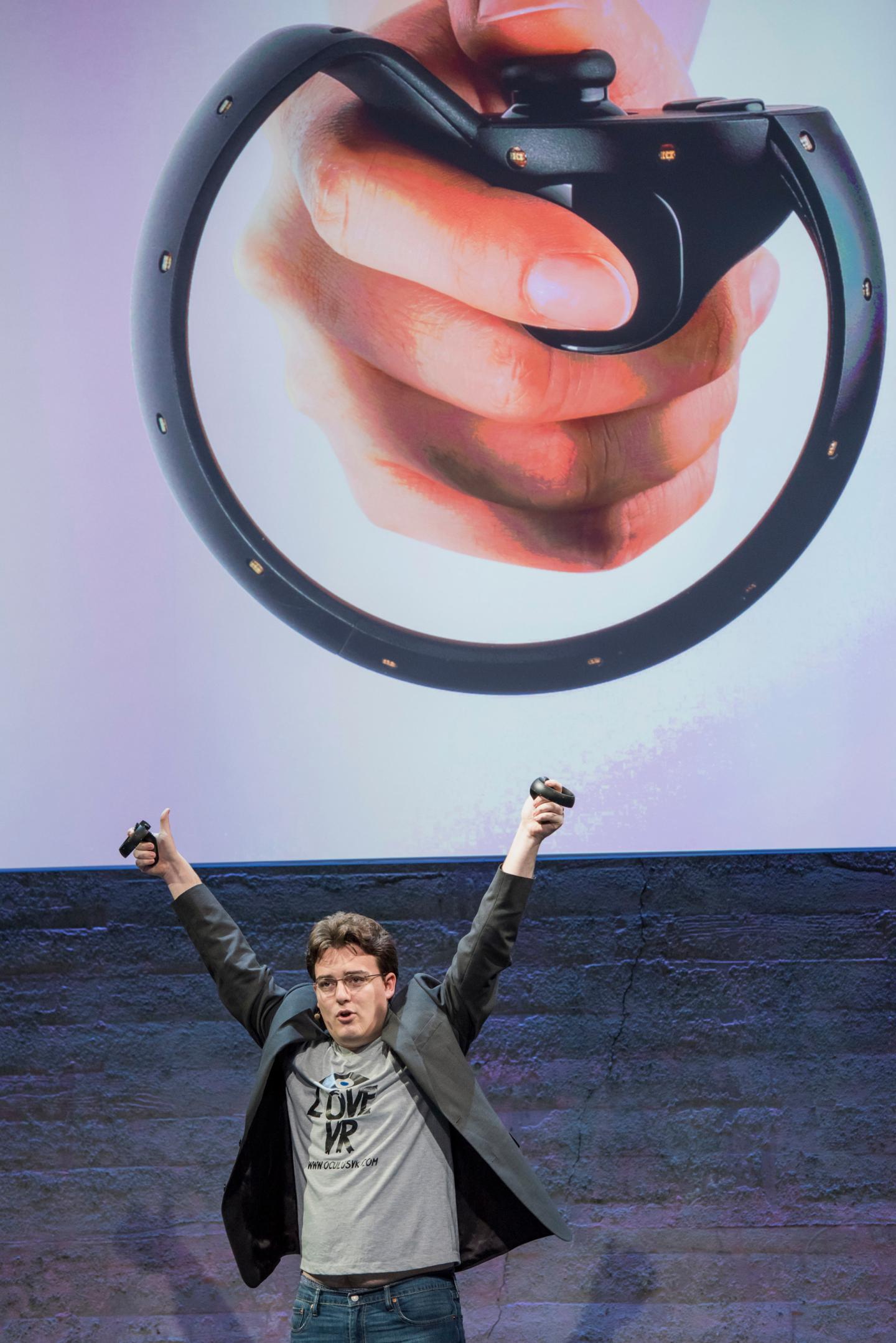 Palmer Luckey, co-founder of Oculus VR. Inc. and creator of the Oculus Rift, holds up the Oculus Touch controller as he speaks during the Oculus VR Inc. "Step Into The Rift" event in San Francisco,   California, U.S., on Thursday, June 11, 2015. Facebook Inc.'s Oculus virtual-reality headsets will work with Microsoft Corp.'s Windows 10 and use the software maker's wireless Xbox game controller. Photographer: David Paul Morris/Bloomberg  *** Local Caption *** Palmer Luckey
