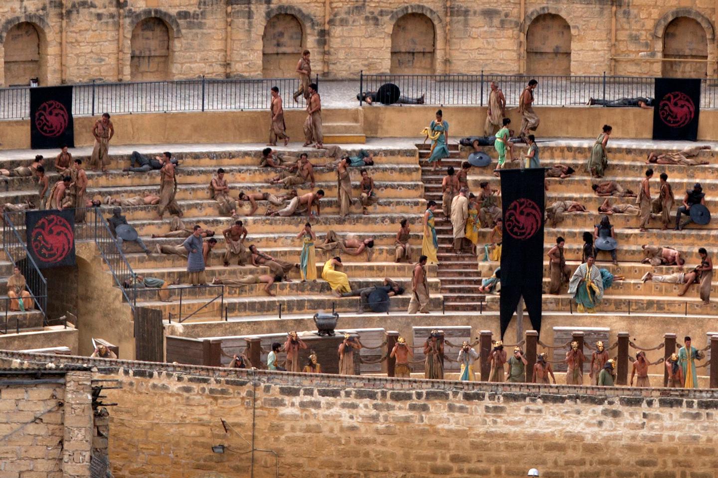 Extras take part in the filming of the fifth season of the HBO TV series "Game of Thrones'" inside a bullring in downtown Osuna