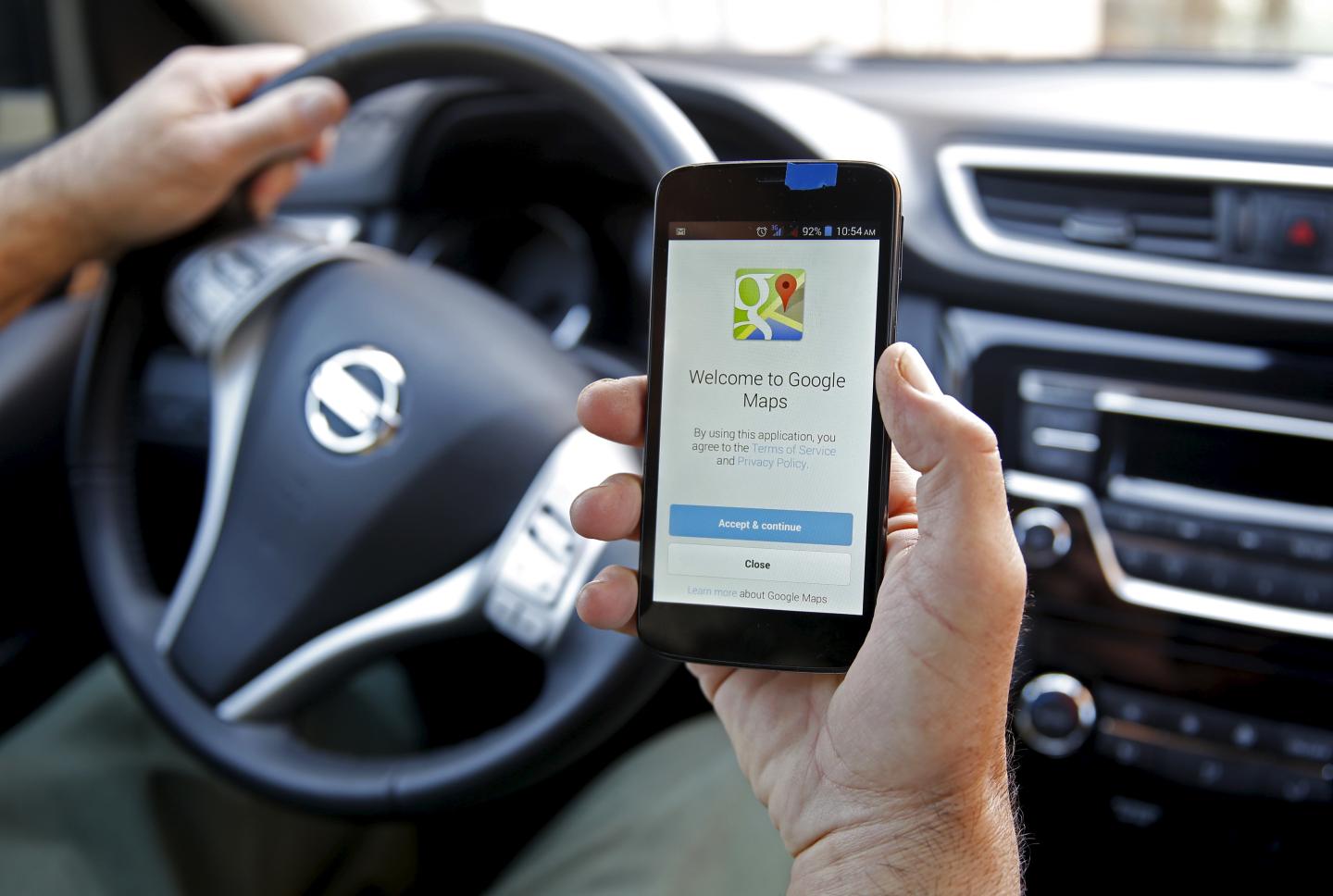 A man holds a smartphone, with the Google Maps app open, in Sarajevo