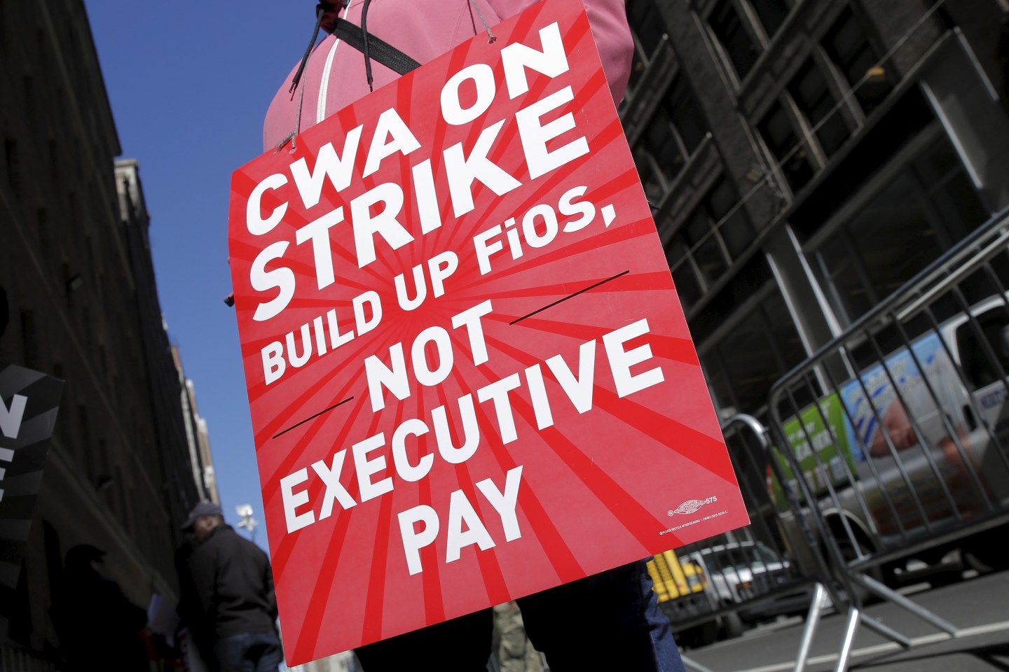A striking CWA member pickets in front of Verizon Communications Inc. corporate offices in New York City