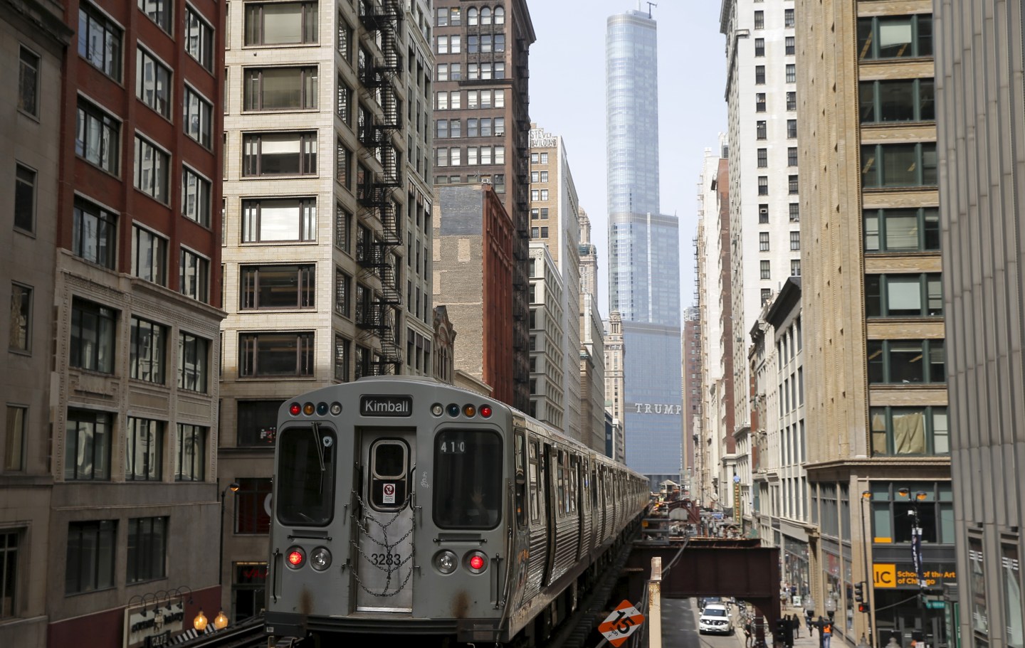 A subway car rides along the tracks towards The Trump International Hotel and Tower in downtown Chicago