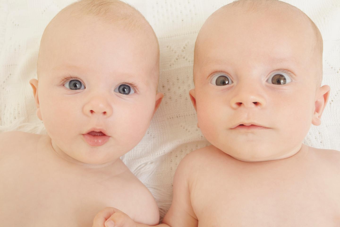 Baby boy and baby girl staring at camera