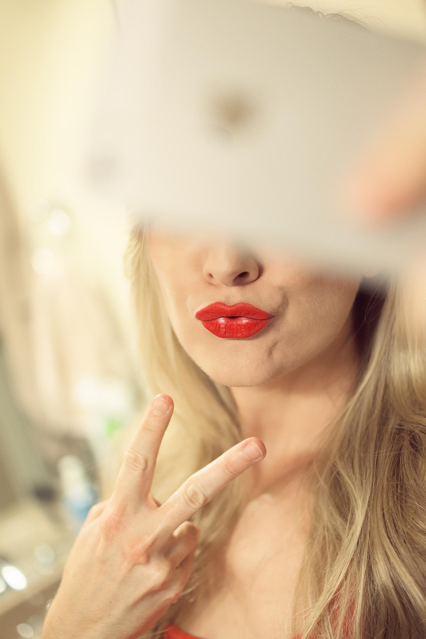 Girl takes a selfie with a "duck face"