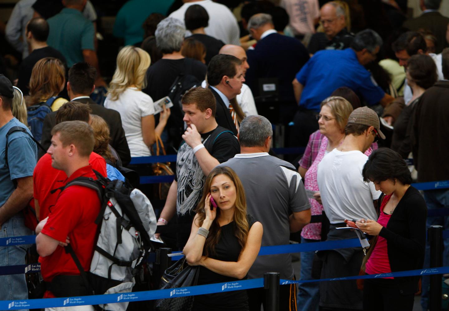 Cellphones help to pass the time in the long lines of through several TSA checkpoints at Los Angele