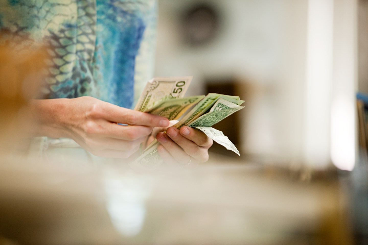 Shop keeper counting money in shop