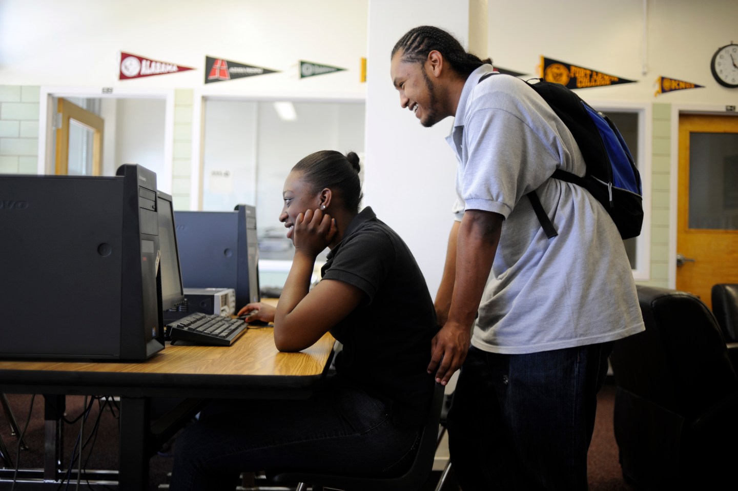 Yvvonne Burrell and Sir Martin look at scholarship information in the Future Center during a school day at Manual High School on Tuesday, May 10, 2011. The Future Center provides the students a place to receive information about financial aid, scholarship