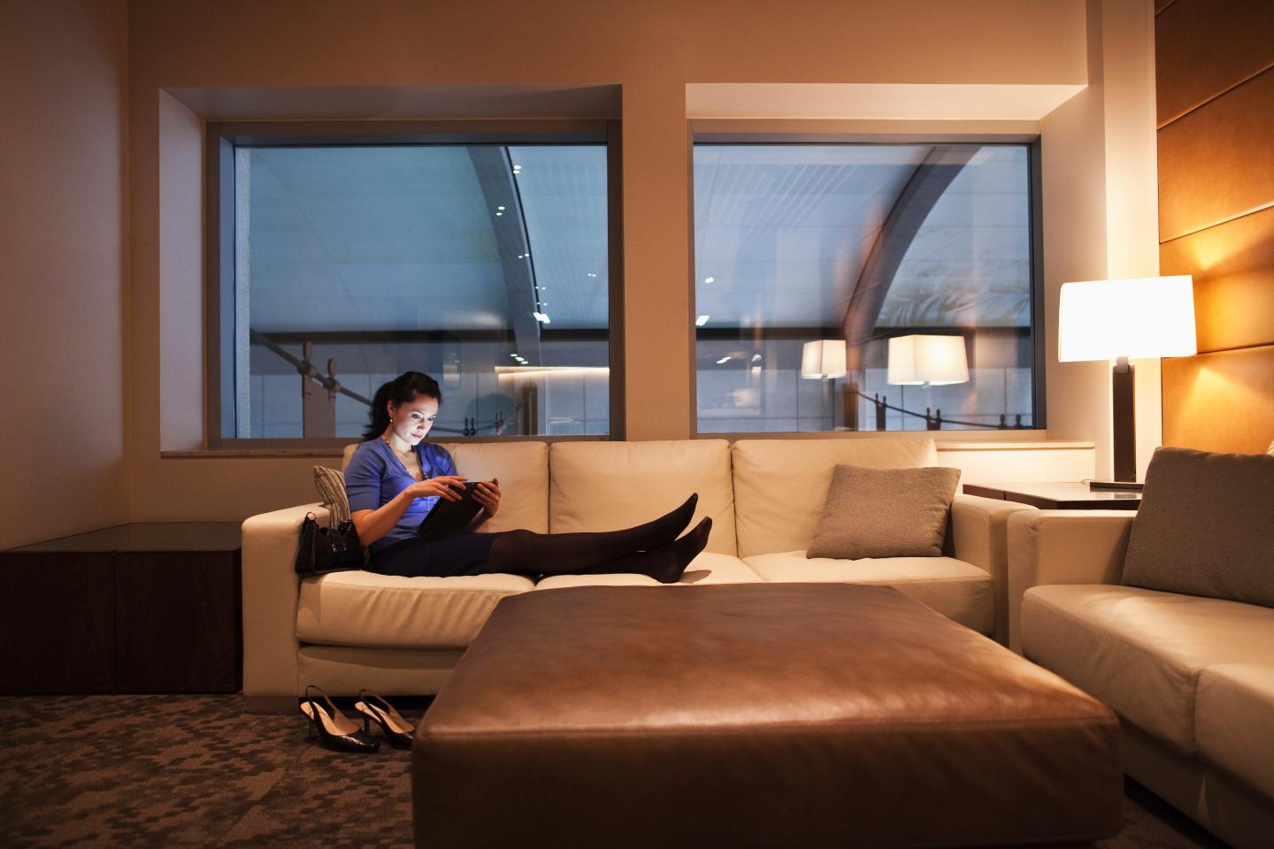Mixed race businesswoman using tablet computer