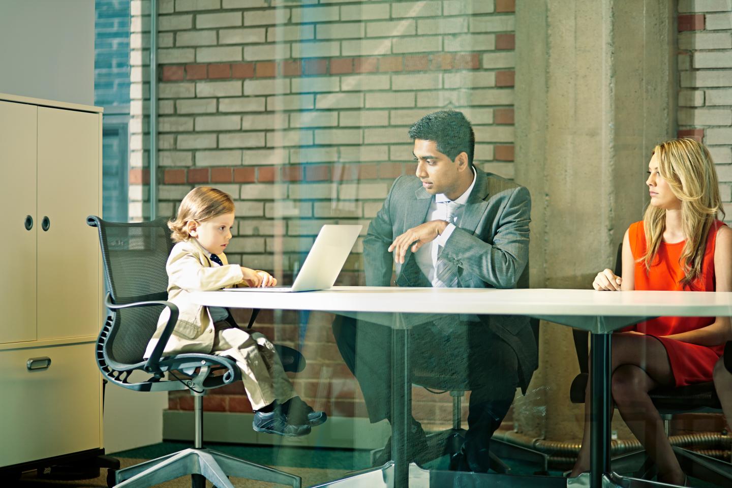 Boy (3-5) chairing business meeting