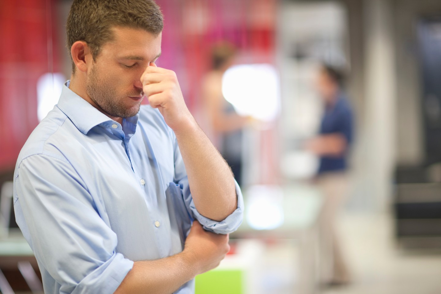 Young businessman looking stressed in office