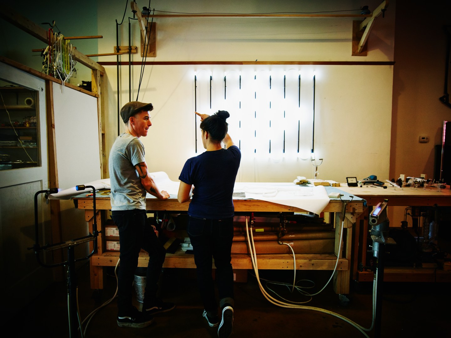 Neon artists discussing neon sign project