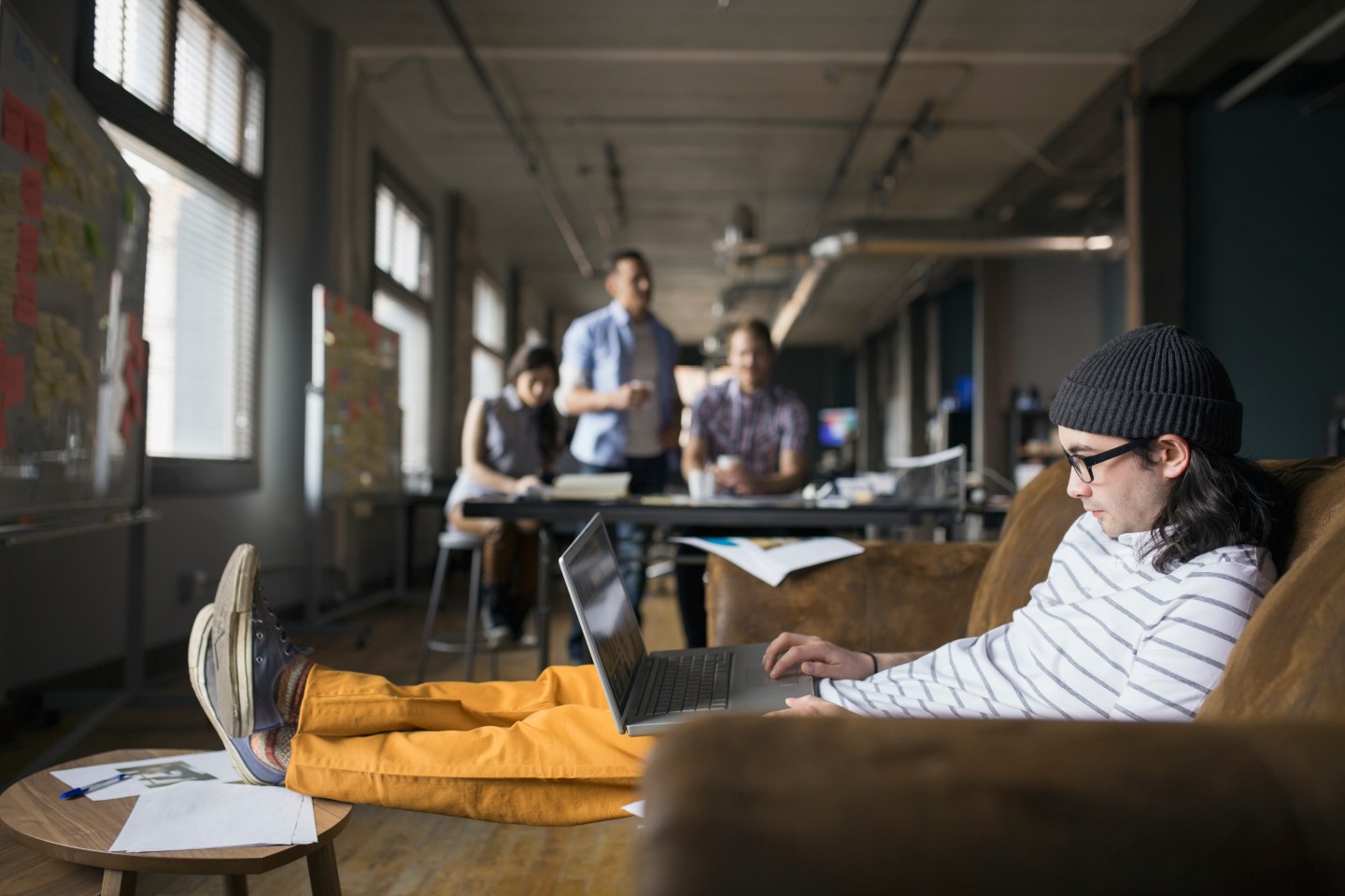 Creative businessman using laptop in office