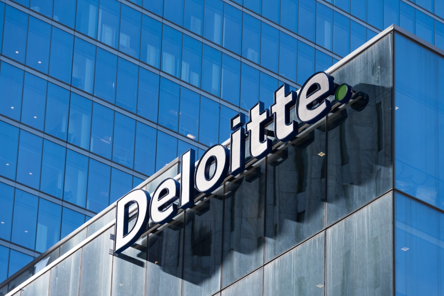 Deloitte sign on top of Toronto headquarters building.