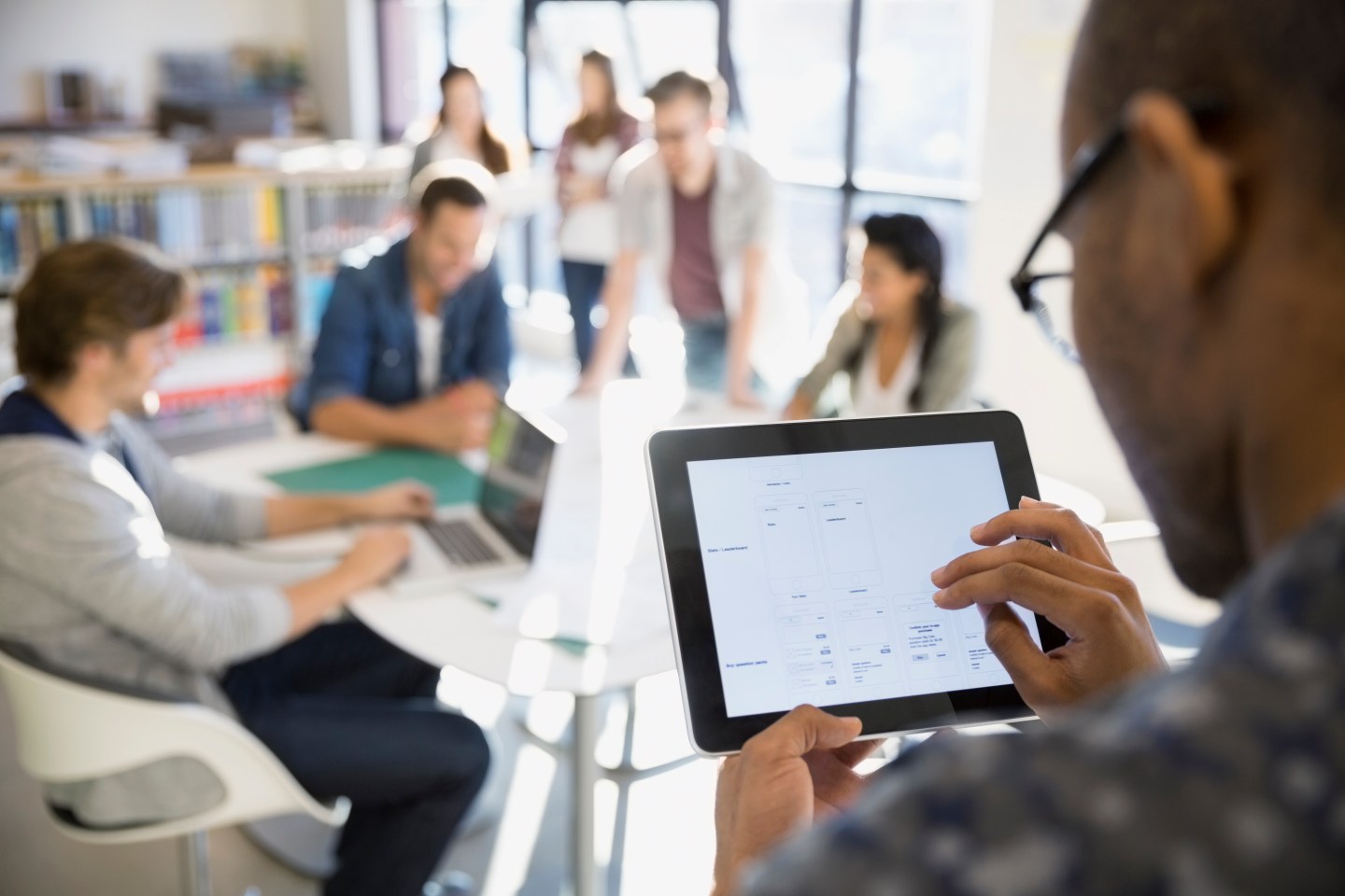 Businessman using digital tablet in meeting