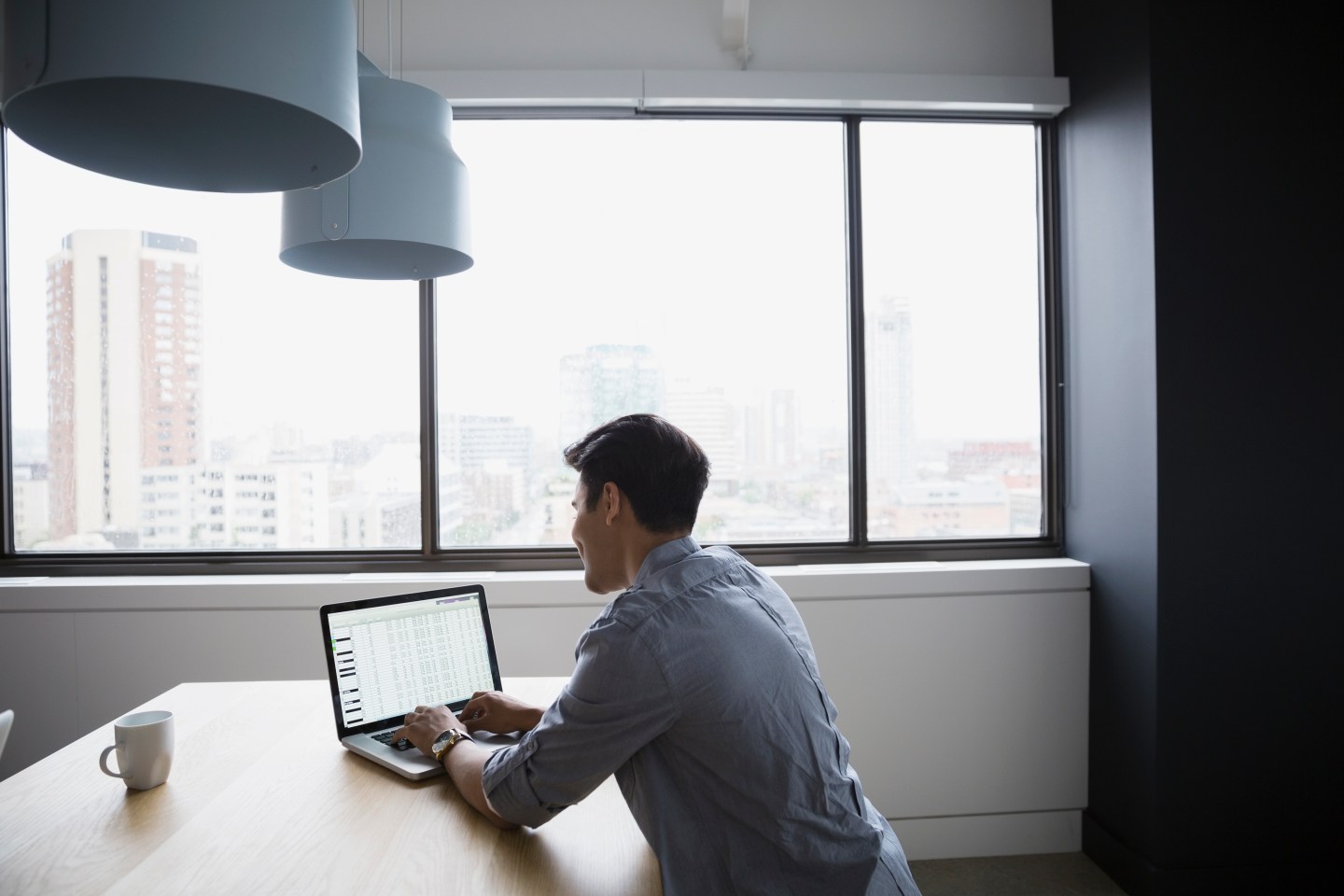Businessman using laptop at table in office