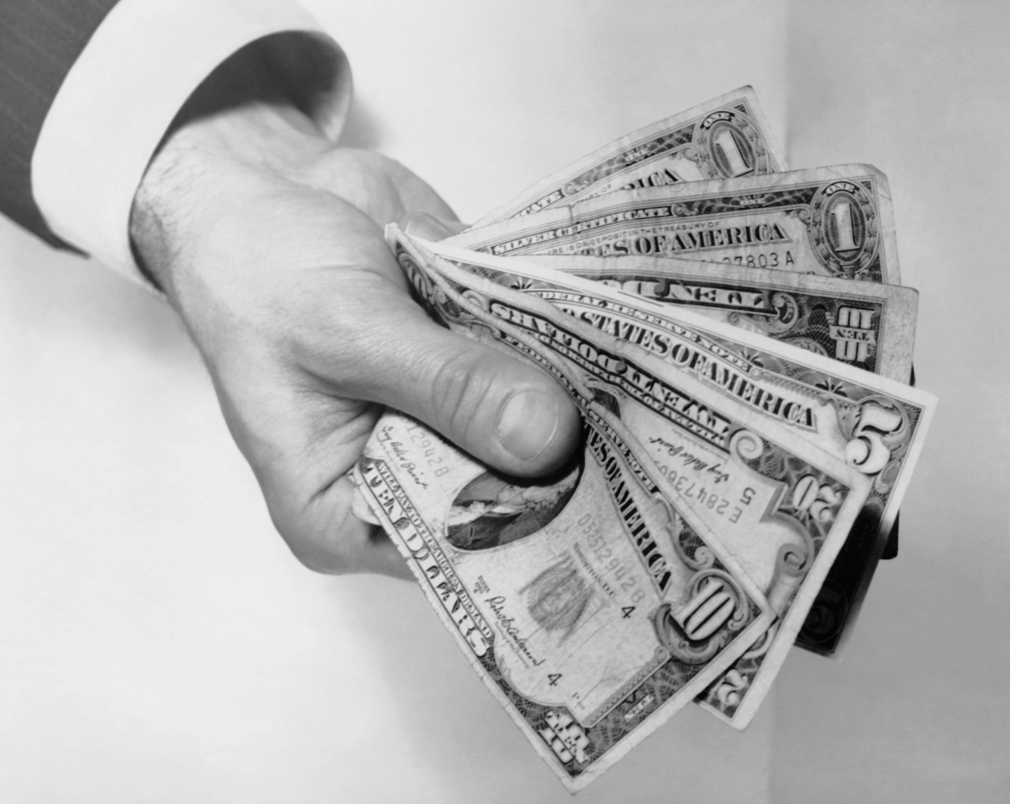 Hand holding out money