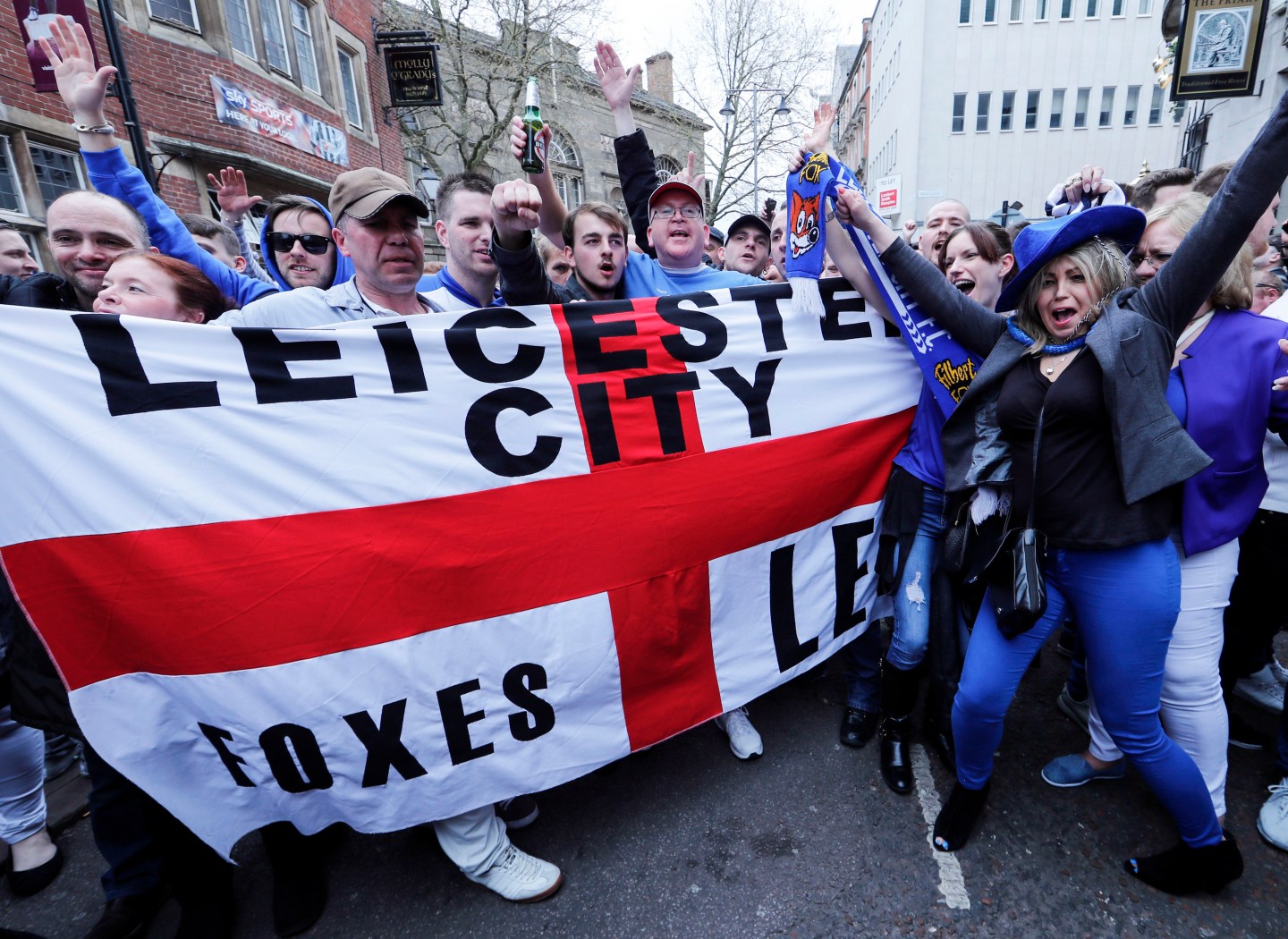 Leicester City fans celebrate in the street after their team's away soccer match against Manchester United, outside Hogarth's pub in Leicester