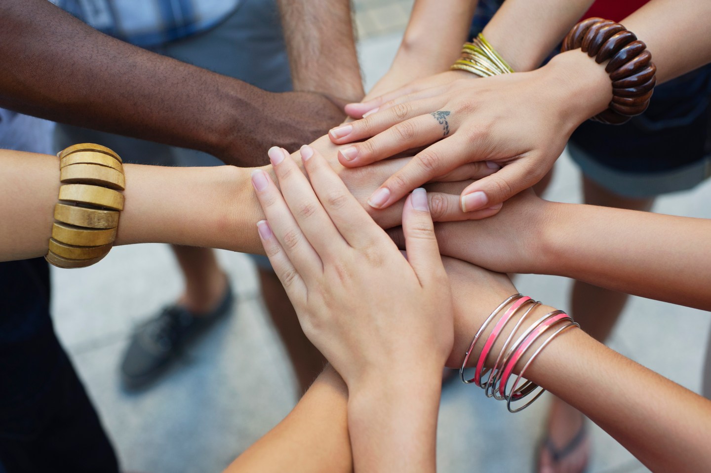 Close-up of human hands stacked upon one another