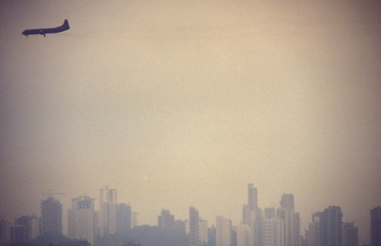 Air pollution. Airplane flies over S?o Paulo city, Brazil