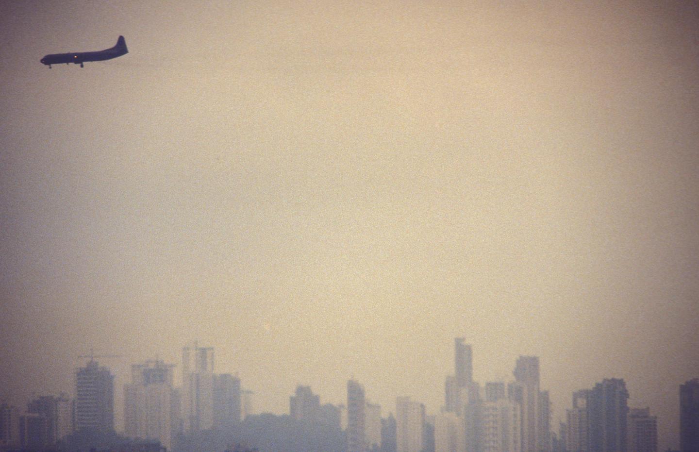 Air pollution. Airplane flies over S?o Paulo city, Brazil
