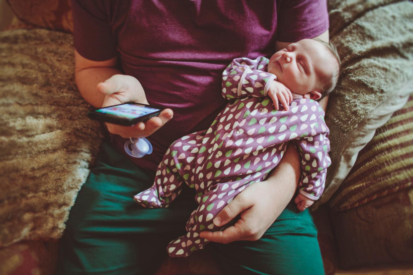 Father with his baby girl using a smart phone