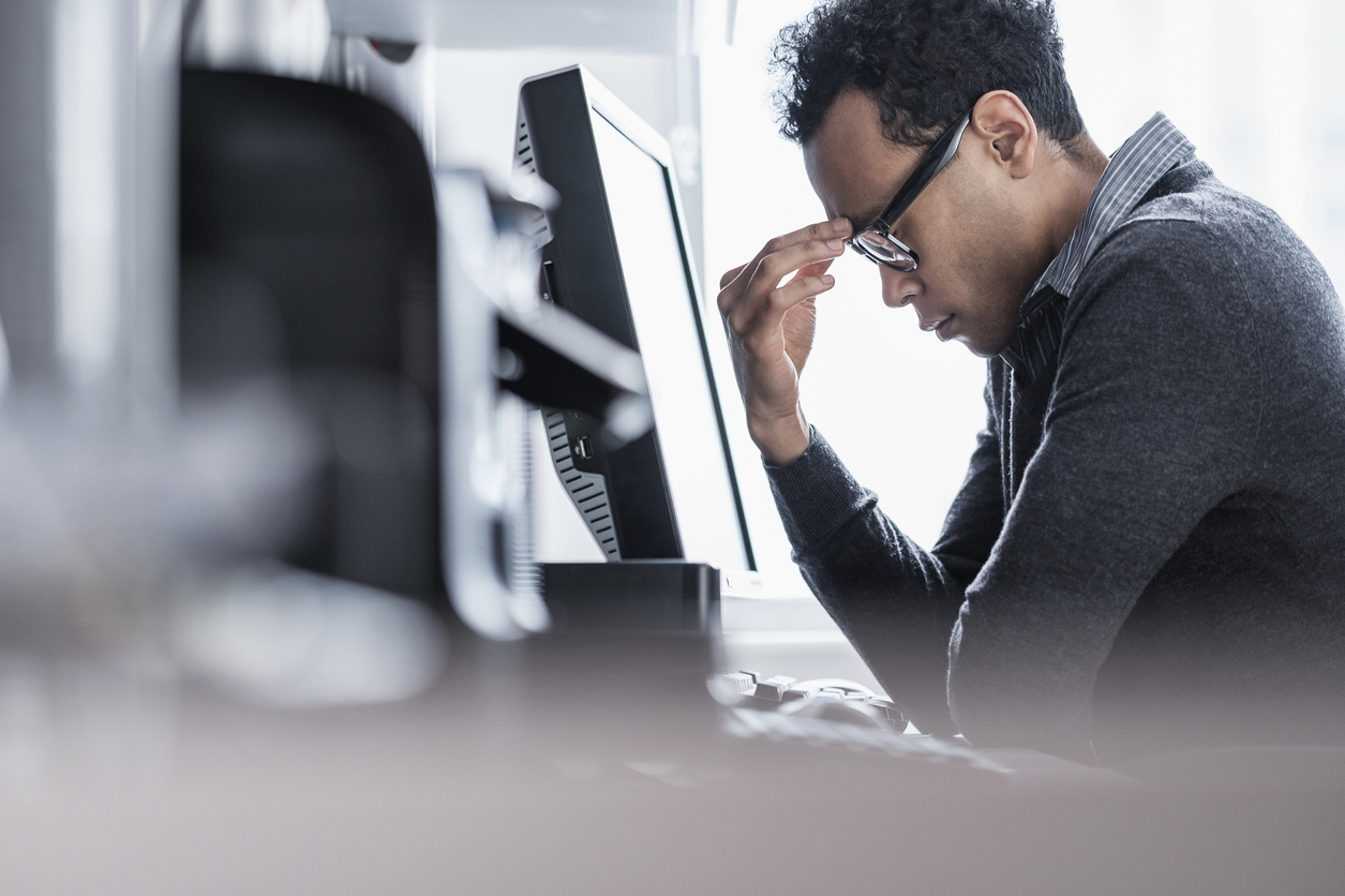 Tired man sitting in office
