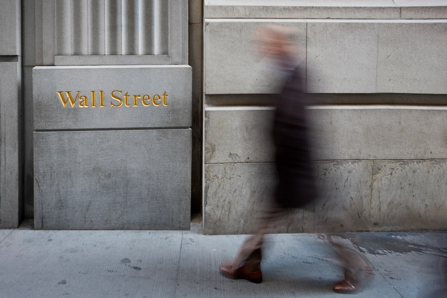 A blurred figure on Wall Street in New York