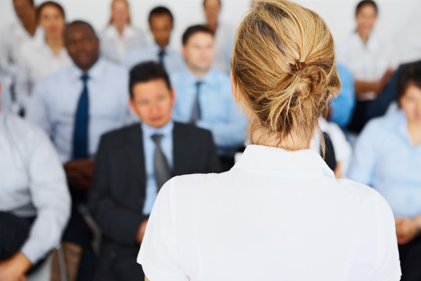 Female giving presentation to her business colleagues
