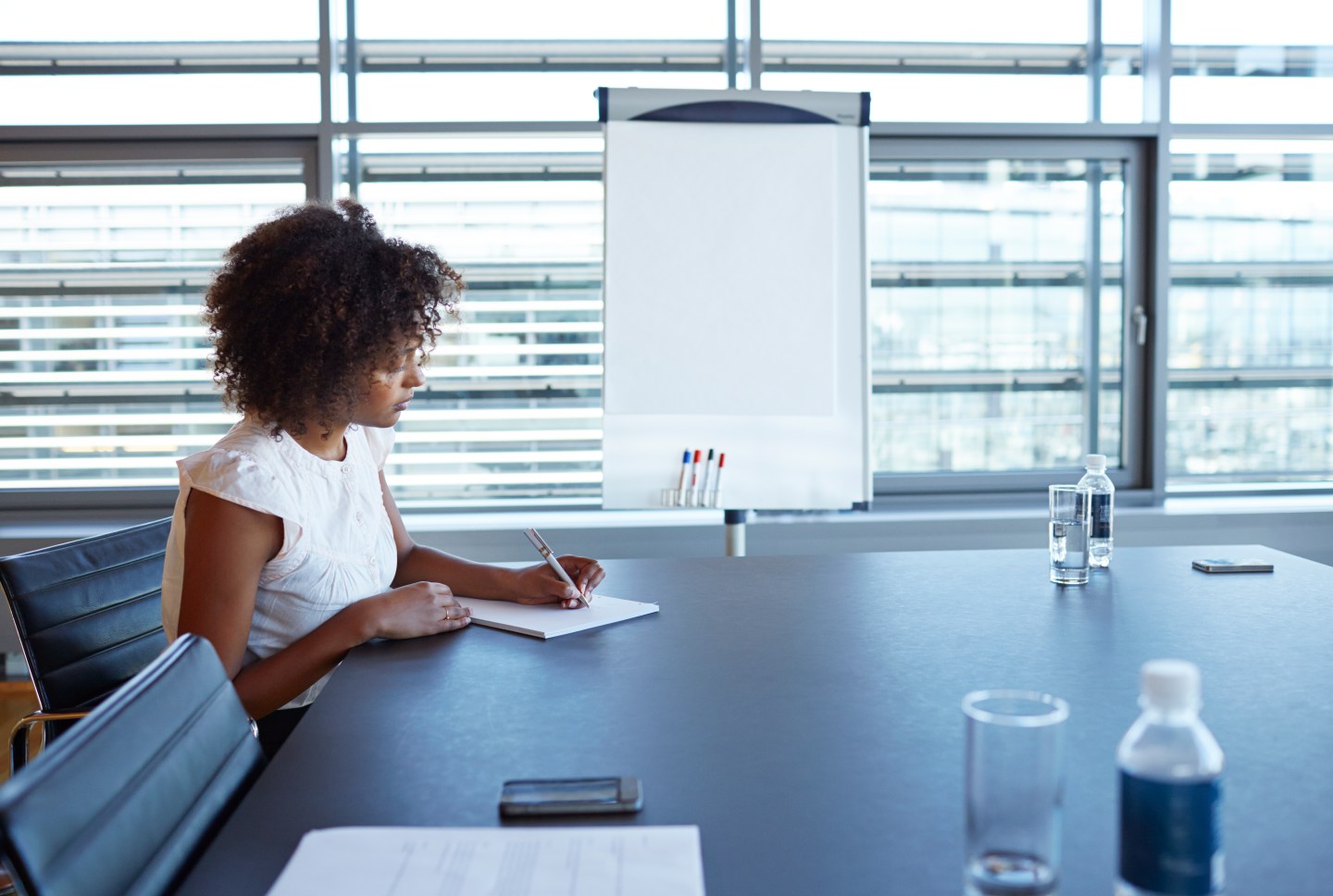 Businesswoman taking notes in conference room