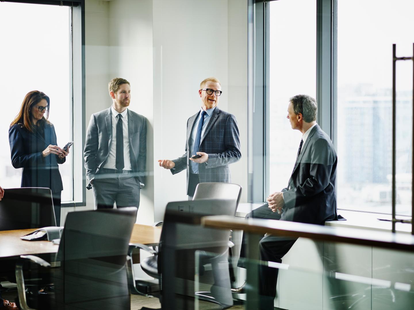 Business executives in discussion after meeting