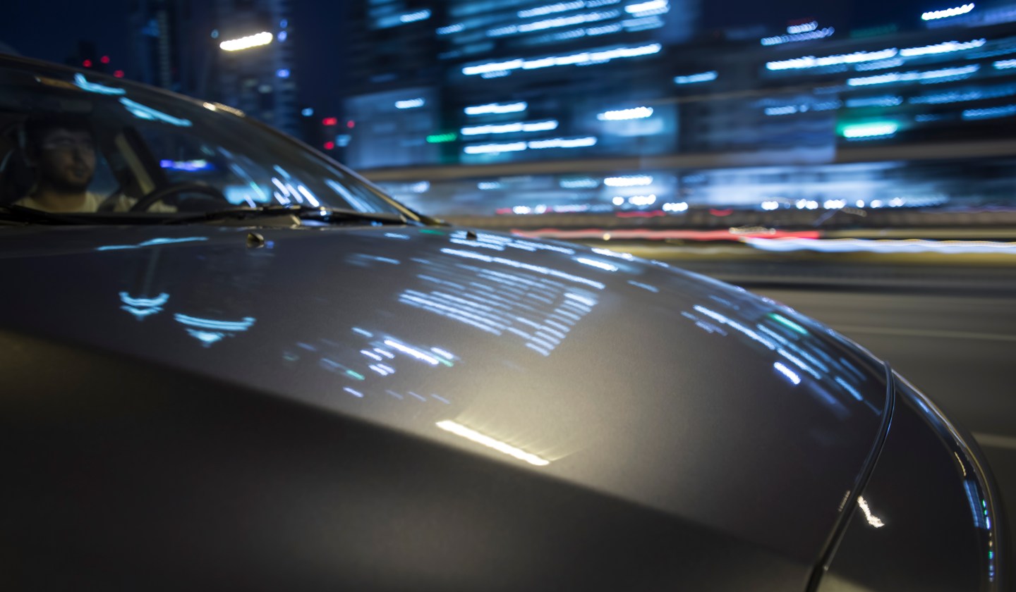 on board a driving car - hood in foreground