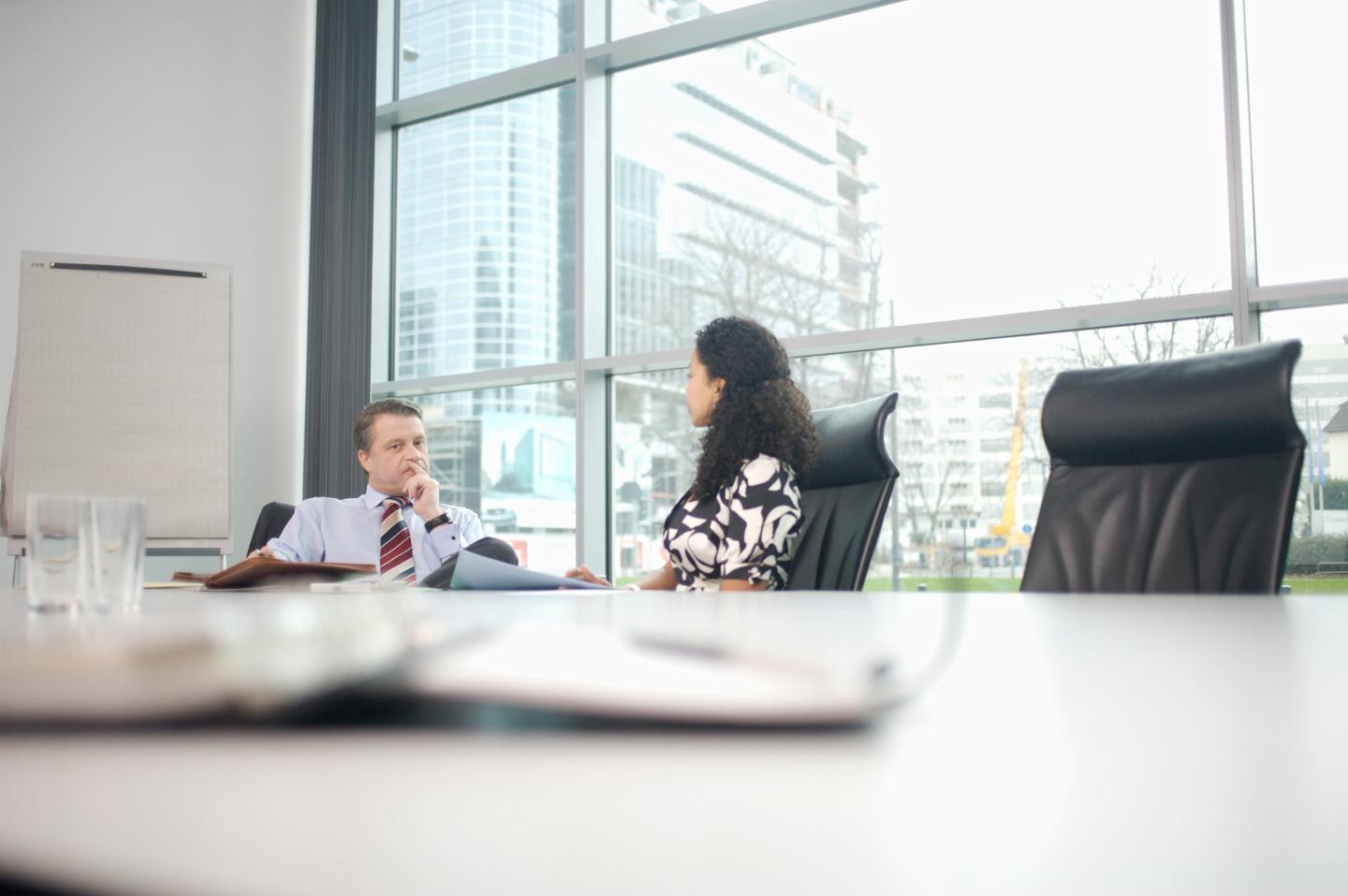 Businesspeople talking at conference table