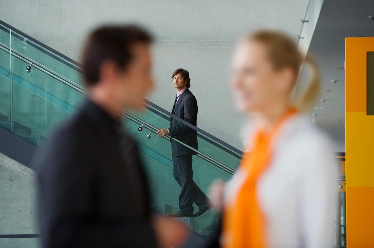 Businessman watching couple talk