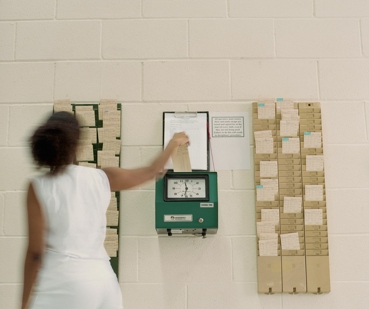 Woman clocking in, rear view (blurred motion)