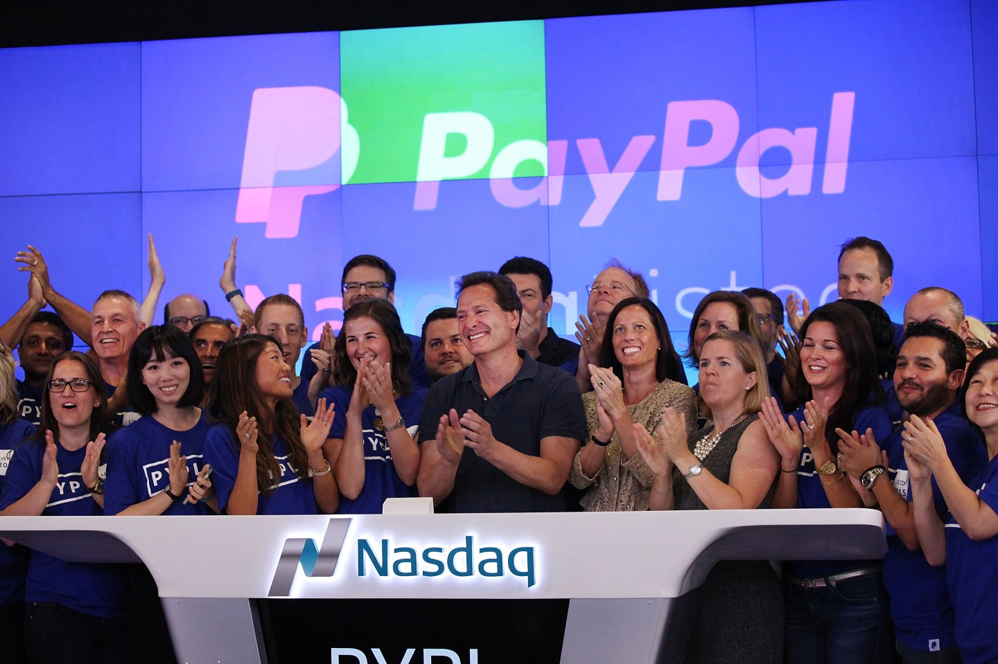 PayPal CEO Dan Schulman (center, with hands clasped) with co-workers on July 20, 2015, the day PayPal&#8217;s stock began trading on the Nasdaq.