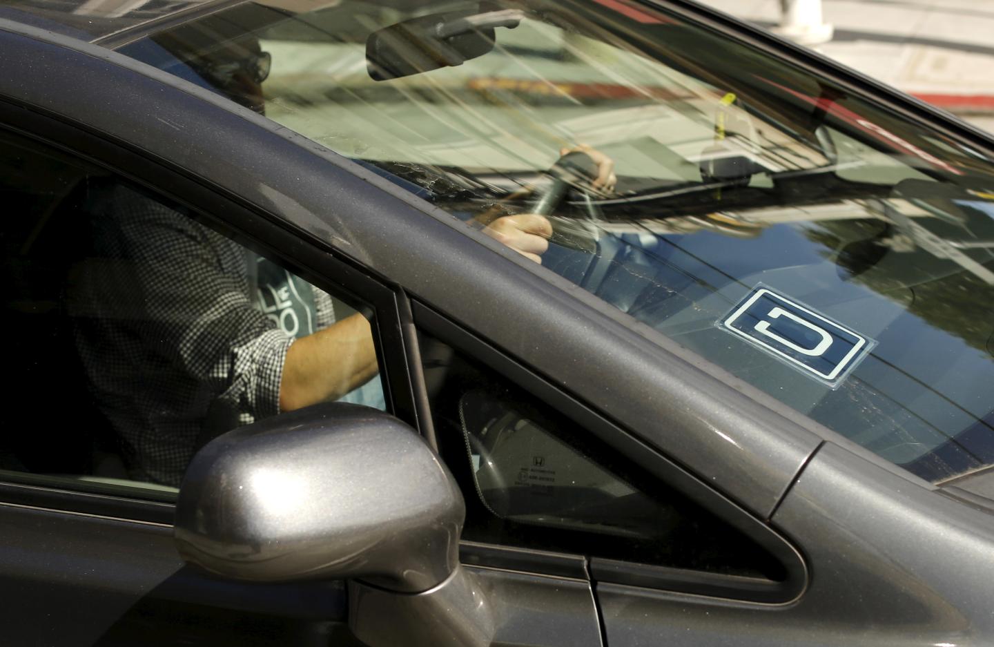The logo for Uber is shown on a vehicle in San Francisco