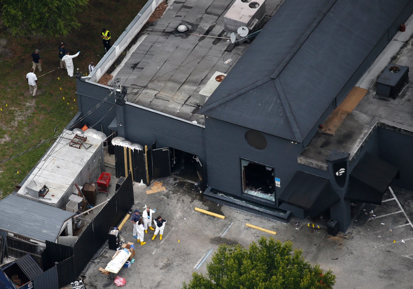 Police forensics investigators work at the crime scene of a mass shooting at the Pulse gay night club in Orlando