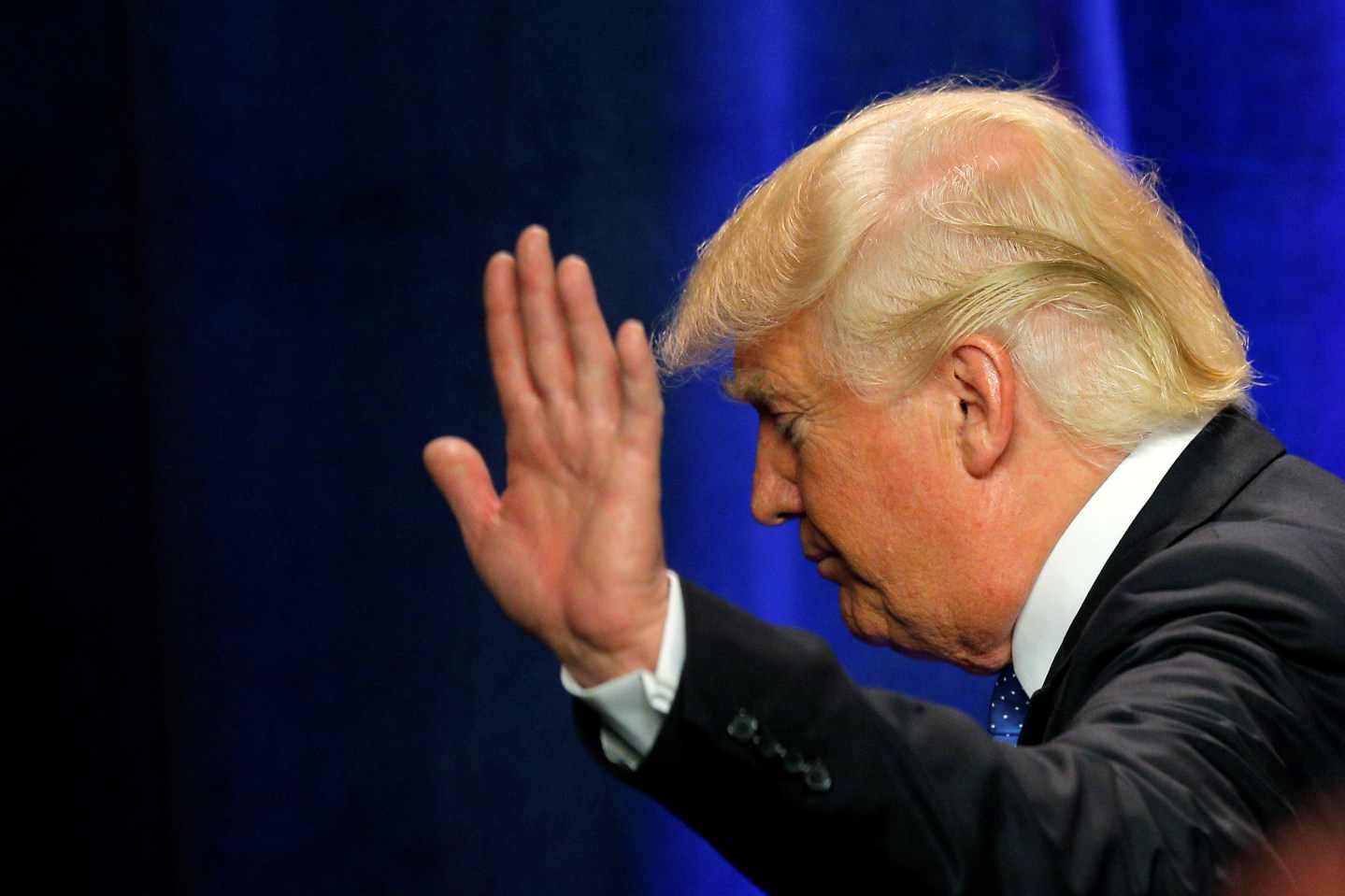 U.S. Republican presidential candidate Donald Trump waves as he walks offstage after delivering a campaign speech about national security in Manchester