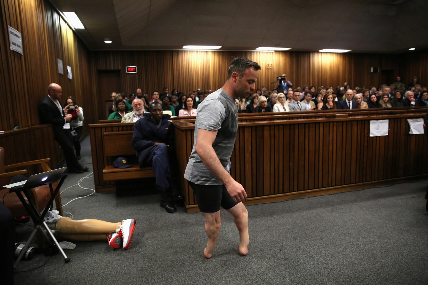 Paralympic gold medalist Oscar Pistorius walks across the courtroom without his prosthetic legs during the third day of the resentencing hearing for the 2013 murder of his girlfriend Reeva Steenkamp, at Pretoria High Court