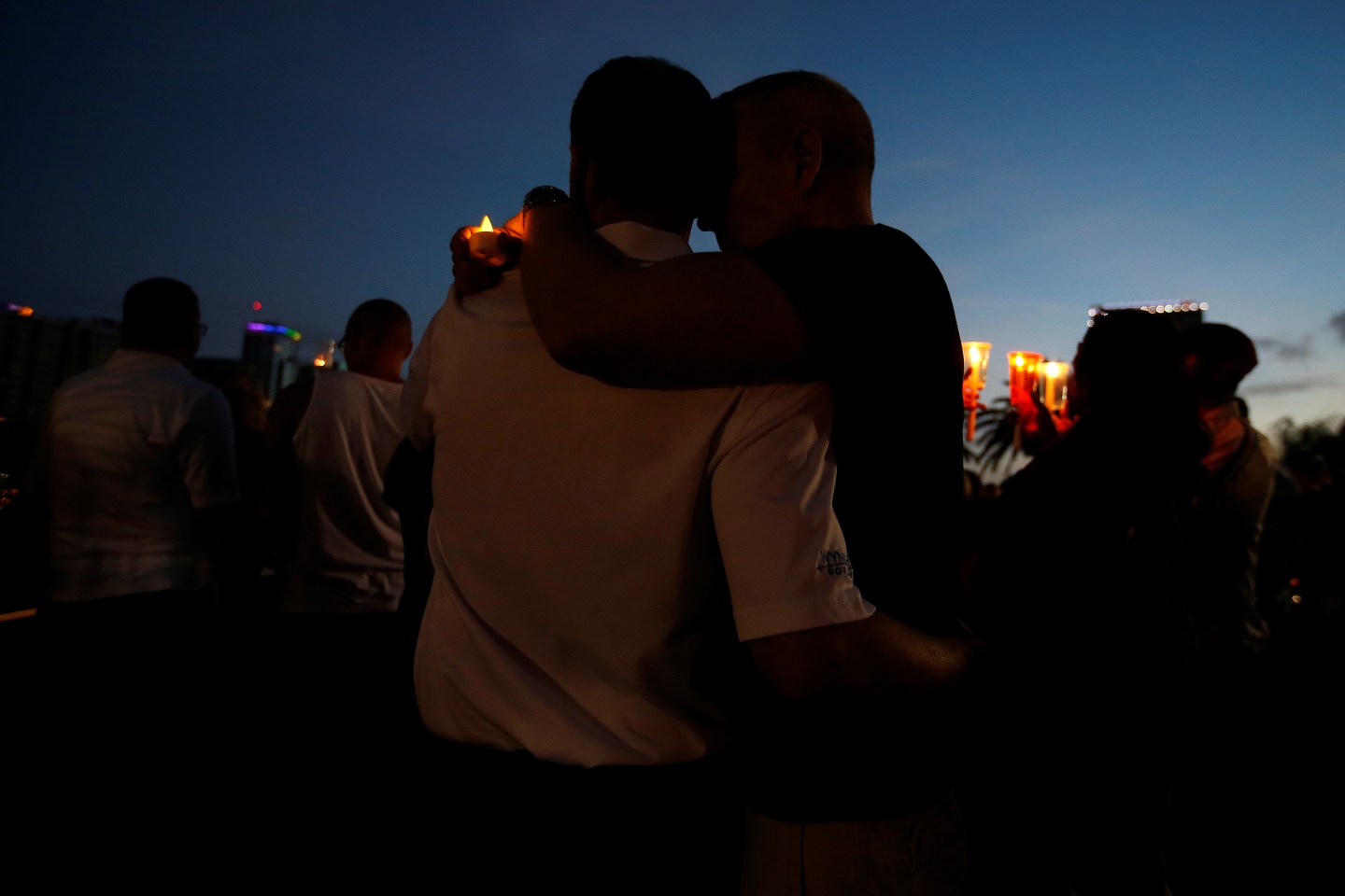 People take part in a vigil for the Pulse night club victims following last week's shooting in Orlando