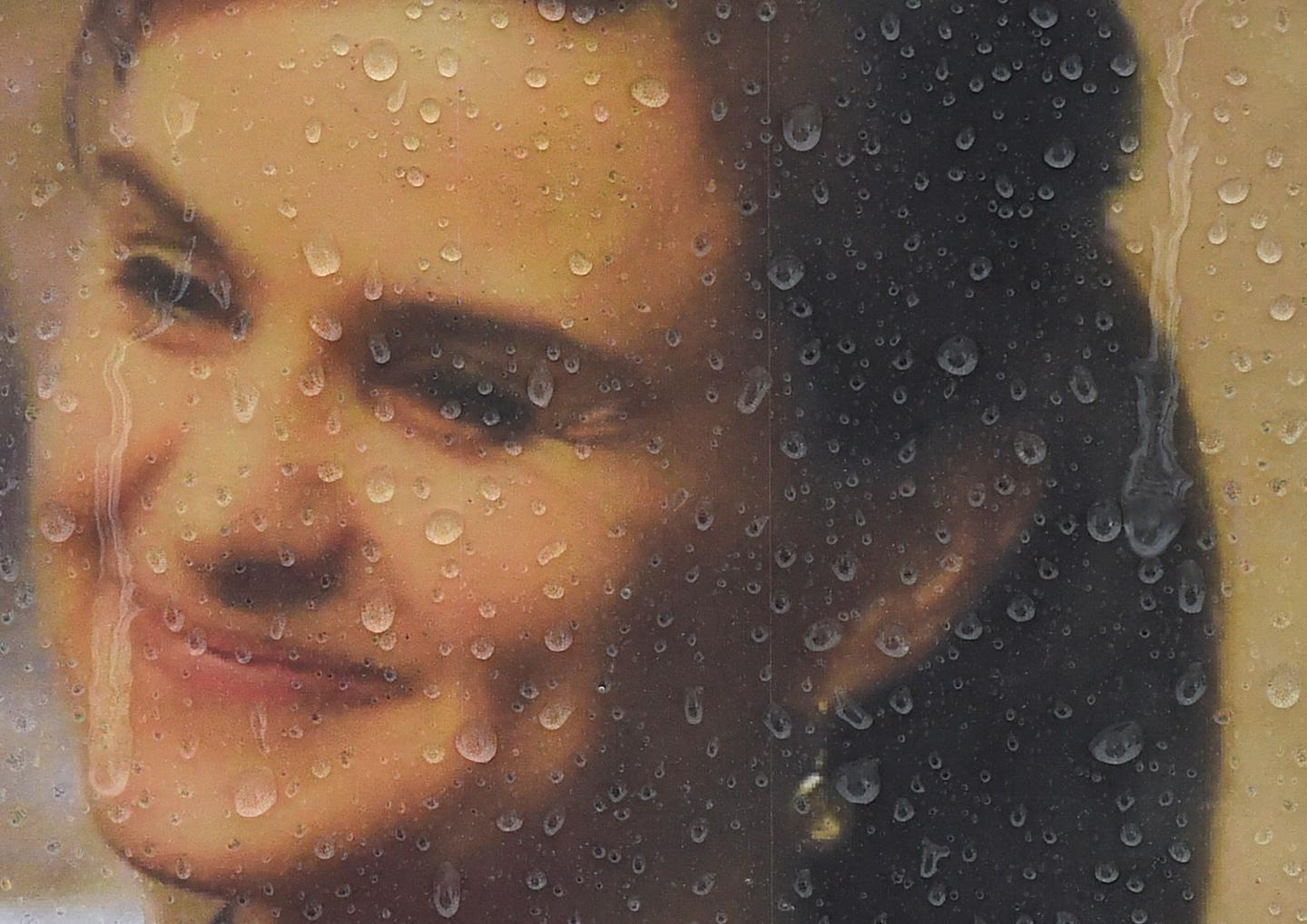 Rain drops land on a framed photograph of murdered Labour Party MP Jo Cox, who was shot dead in Birstall, at Parliament Square in London, Britain