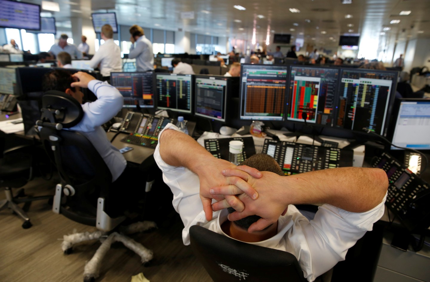 A trader from BGC, a global brokerage company in London's Canary Wharf financial centre reacts during trading