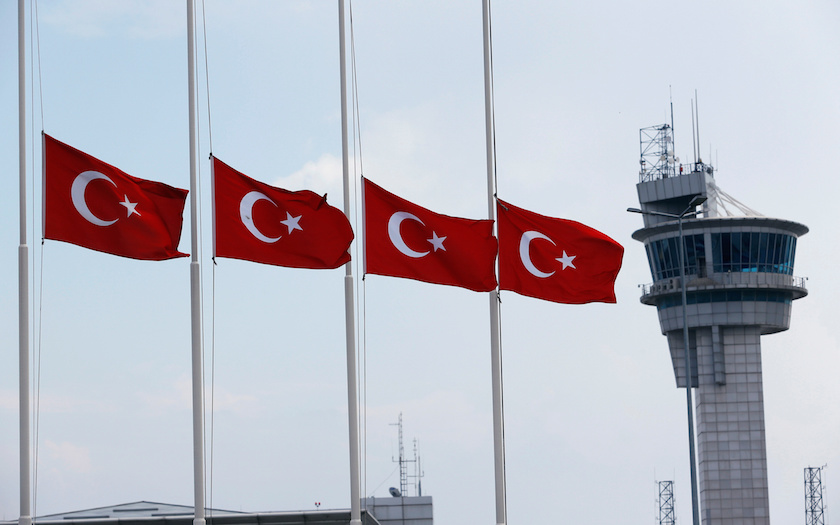 Turkish flags, with the control tower in the background, fly at half mast at the country's largest airport, Istanbul Ataturk, following yesterday's blast in Istanbul