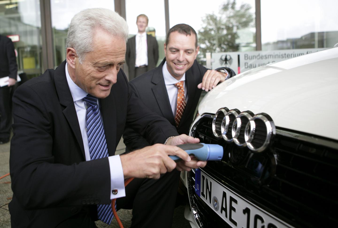GERMANY, BONN, DR Peter RAMSAUER (CSU), Federal Minister of Transport, Building and Urban Affairs, with an electric charging cable next to the AUDI A1 e-tron.