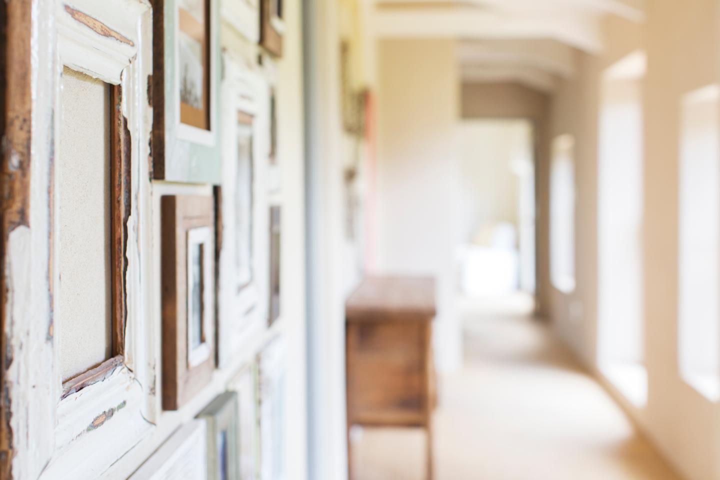 Decorative wall frames in rustic hallway