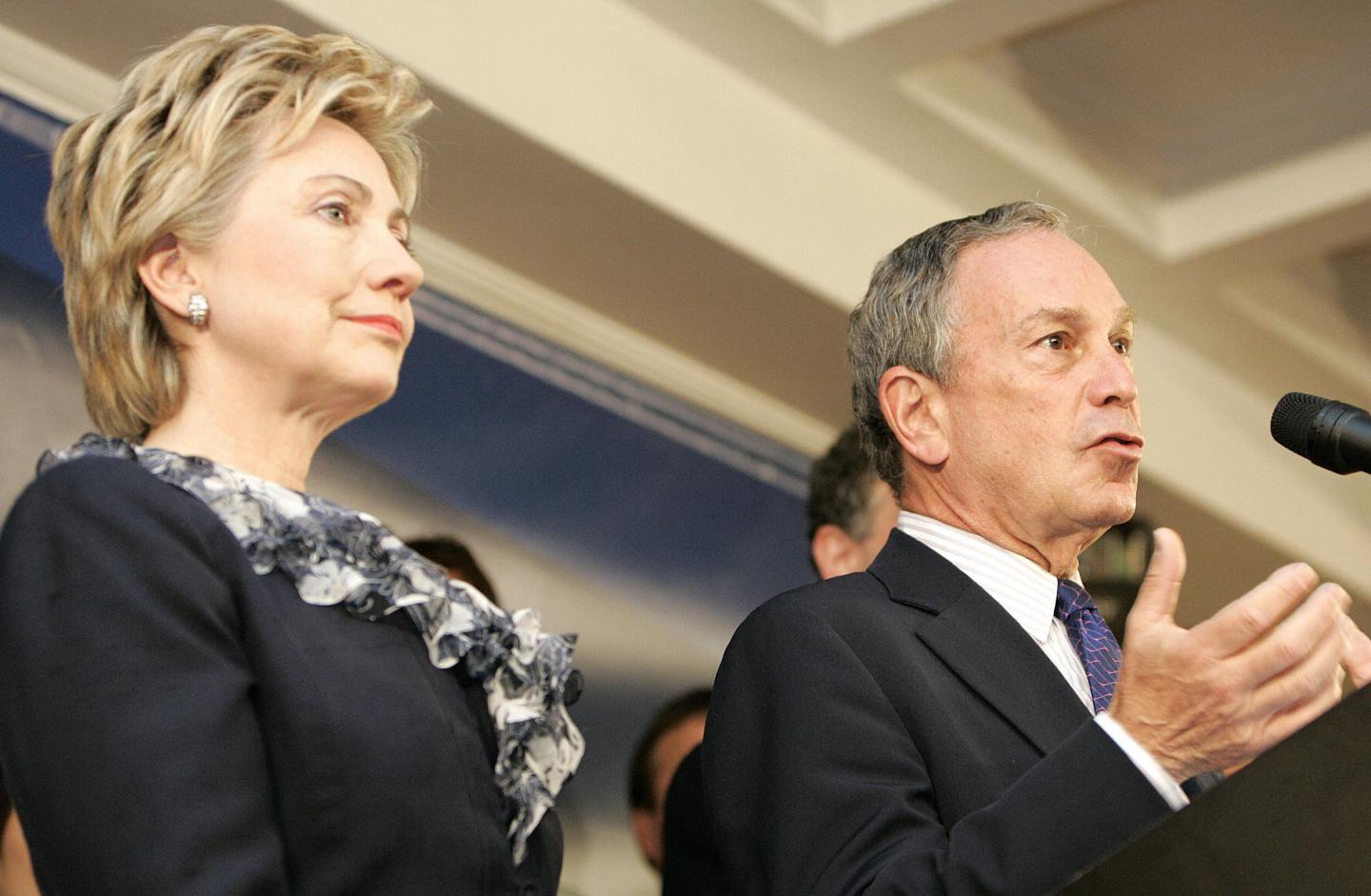 US Senator Hillary Clinton (L) looks on