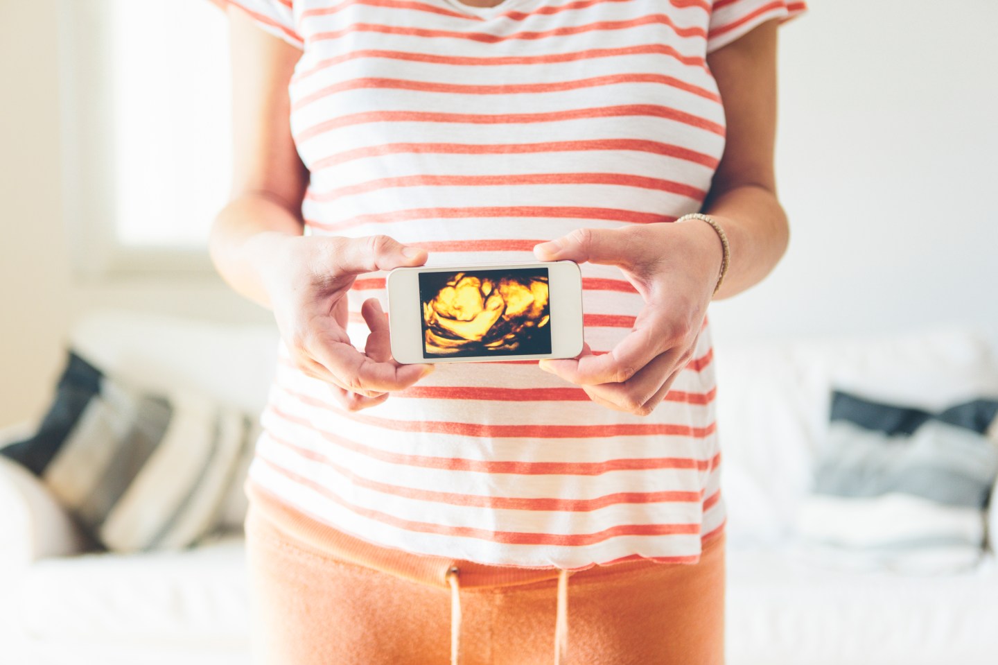 Pregnant woman showing a photo from her unborn chi